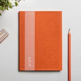 A hardcover notebook with an embossed geometric pattern in a vibrant orange color. The notebook appears to be part of a collection called "Vienna" and is available in multiple color variants including blue, yellow, rust, green, lavender, and concrete.