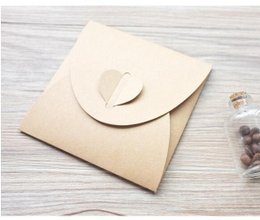 Craft paper envelope with heart-shaped closure, 130x130mm, suitable for gifts or cards.