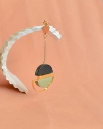  Dangling olive-shaped earrings with gold-tone accents and a modern, geometric design.