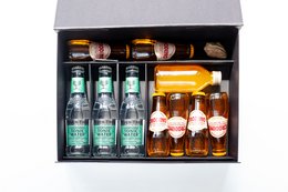 Mocktail set with 3 bottles of Crodino, a non-alcoholic Italian aperitif, and 2 glasses in an orange color.