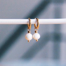 Gold-tone hoop earrings with freshwater pearl drops. Elegant and versatile accessory for any occasion.