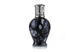 Black glass fragrance lamp with intricate design. Features a tall, cylindrical shape and a decorative metal top. Suitable for use with essential oils or fragrance diffusers.