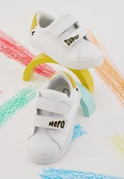 White sneakers with colorful accents and a superhero-inspired design, suitable for kids.
