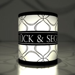 5 graphic lucky & blessing transparent lights, black tea light holders with a geometric pattern and the text "Glück & Segen" (Luck & Blessing) printed on the surface.