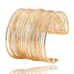 Gold plated cuff bracelet with multiple parallel wire bands, wide statement style, shiny metallic finish, elegant fashion jewelry