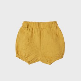 Organic muslin bloomer shorts in a mustard yellow color, suitable for infants and toddlers. Features a relaxed, comfortable fit with an elastic waistband.