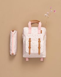 A white backpack with pink floral patterns, featuring a main compartment, two side pockets, and a top handle. The backpack is designed for kids and suitable for everyday use.