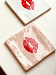 Peach-colored poster with red heart shapes, suitable for decorative or romantic purposes.