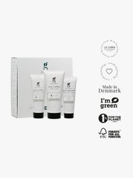 A set of three cream-based products in white tubes, featuring the brand name "the scrub box". The products appear to be skincare or beauty items, potentially for exfoliating or cleansing the skin.