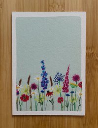 Colorful floral birthday card with assorted wildflowers including blue and purple blooms.