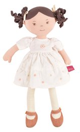 A soft, plush baby doll with a white dress featuring a floral pattern. The doll has dark hair in pigtails and a friendly, smiling expression.