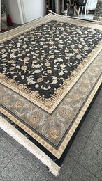 Large dark blue area rug with intricate floral and geometric patterns, suitable for living rooms or bedrooms.