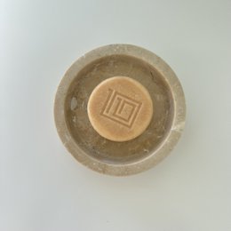 Solid, sustainable hand and body wash bar made of natural ingredients. Rectangular shape with embossed logo design.