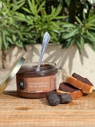 Savory anchovy spread with black olives, perfect for crackers or bread. Rich, salty flavor with a smooth texture.