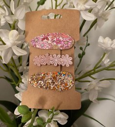 Set of 72 colorful hair clips for kids, featuring floral and glitter designs in various shades of pink.
