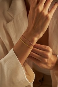 GEWEVEN ARMBAND GOUD
