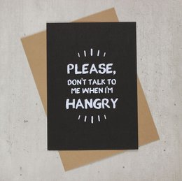 Large black greeting card with white text that says "PLEASE, DON'T TALK TO ME WHEN I'M HANGRY". The card has a kraft paper envelope with a leopard print pattern.