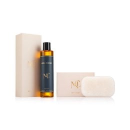 Luxury golden amber shower oil set with cream soap bar, elegant beige packaging, citrus lemon scent.