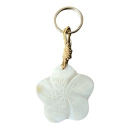 Pale green jade flower keychain with rope attachment, delicate petal design, natural stone charm.