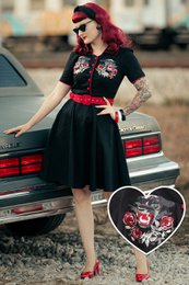  Black dress with red trim and panther embroidery, rockabilly style, knee-length skirt, short sleeves.