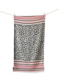 A leopard print bath towel with a pink and white striped border, suitable for a modern bathroom.