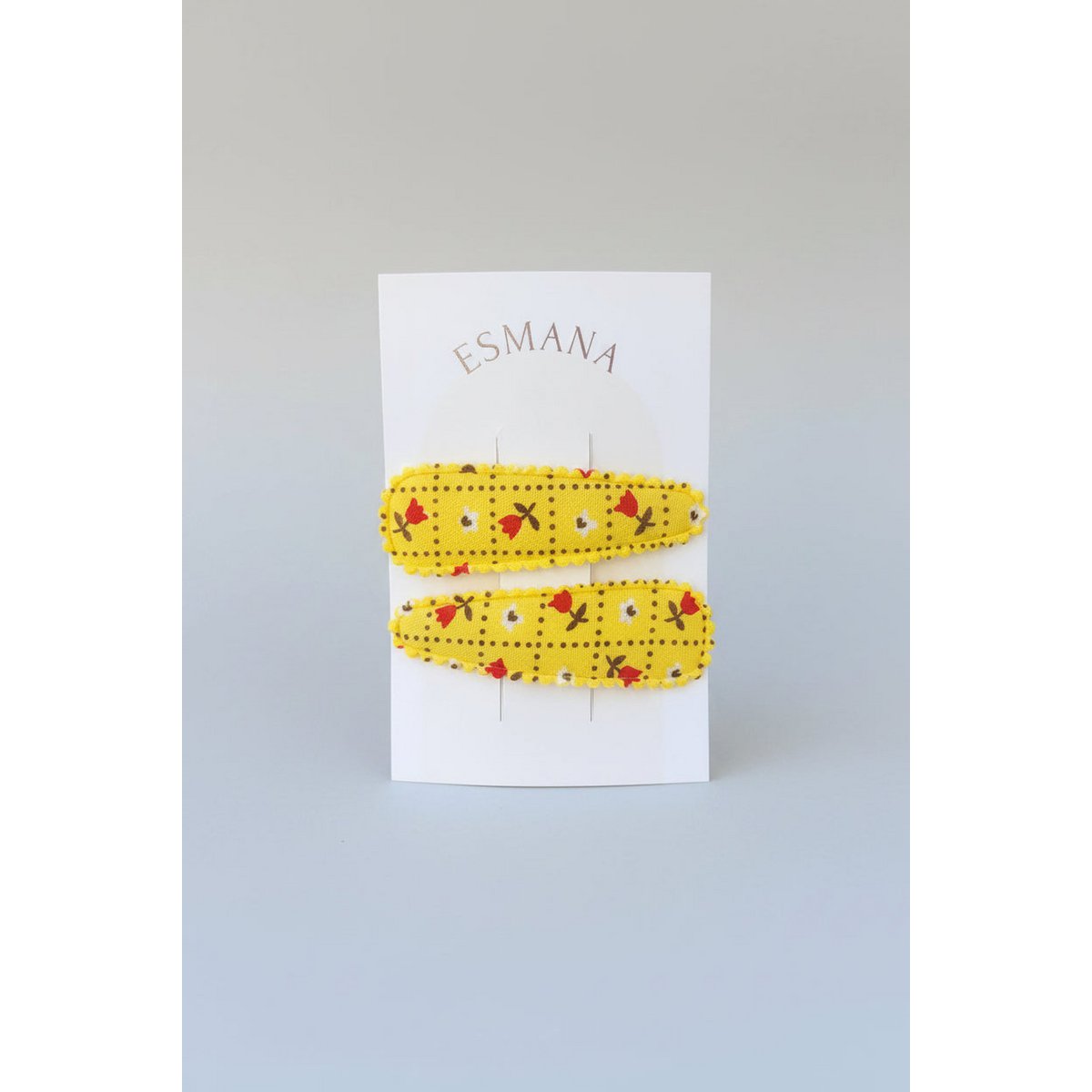 Moschettone da bambino giallo con fiorellini