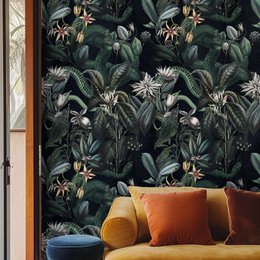  Dark botanical wallpaper with lush, tropical foliage in shades of green, featuring large leaves, flowers, and other botanical elements. The wallpaper has a rich, moody color palette and a bold, nature-inspired pattern.
