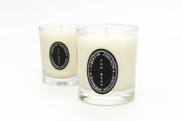Saffron-scented candle with a tall, round shape and a classic, elegant design.