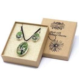 Pressed flower pendant set with a tree of life design in green. Includes a necklace and matching earrings in a gift box.