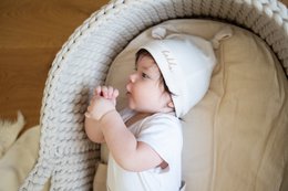 Neutral-colored newborn gift set including leggings and knot hat in sizes NB, 3m, 6m, 9m.