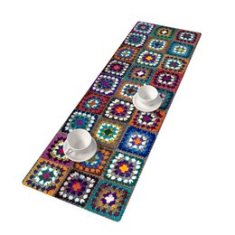 A colorful, patterned table runner made of felt, measuring 33 x 95 cm. The runner features a vibrant granny square design in various colors and shapes, creating a visually striking and textural piece for a dressing table.