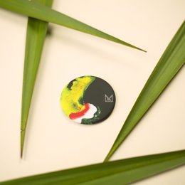 Colorful abstract magnetic bottle opener with a unique circular design featuring a vibrant pattern.