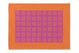 2 placemats with a repeating floral pattern in orange and magenta colors