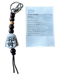 White Buddha face keychain, black beads, spiritual charm, woven cord attachment, travel accessory.