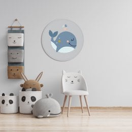 A round wall decor featuring a cute cartoon whale with a heart and stars, suitable for a kids' room.