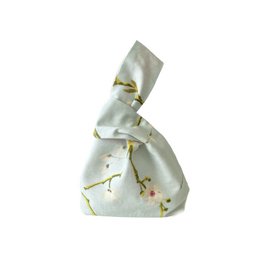 Elegant Japanese-inspired handbag with delicate cherry blossom print in soft pastel colors.