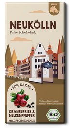 Dark chocolate bar with organic cranberries and pink peppercorns. Rectangular shape with a city skyline design on the packaging.