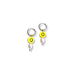 Silver earrings with smiley face charms and pearl accents.