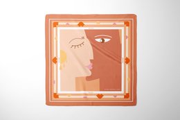Silk square scarf in terracotta color, featuring a stylized face design. Measures 67 x 67 cm.