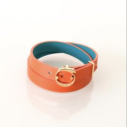 Vibrant orange and turquoise leather cuff bracelet with a round metal buckle closure, available in sizes XS to L.