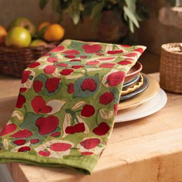 A green tea towel with a vibrant red fruit pattern, suitable for use in the kitchen or as a decorative accent.