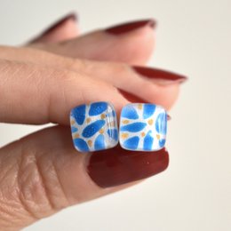 Small glass earrings with sterling silver posts, featuring cerulean blue leaves and golden berries.