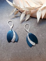  Elegant drop earrings in a deep teal blue color, featuring a textured surface and sparkling accents for a stylish look.