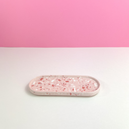 Oval-shaped decorative tray in a blush terrazzo pattern, made of ceramic material.