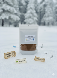 A small white package containing propolis, a natural bee product, sits in the snow. The package is labeled in German, indicating it is a winter health product containing propolis for the hands.