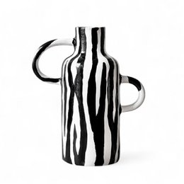  Tall, cylindrical vase with bold black and white striped pattern, suitable for decorative or functional use in the home.
