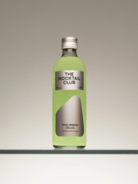 A green, bottled mocktail with a fresh, herbal aroma and a garnish of a lemon slice and mint leaves in a cocktail glass.