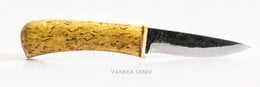 A yellow-handled kitchen knife with a black blade. The handle appears to be made of a textured material, possibly wood or a synthetic material.
