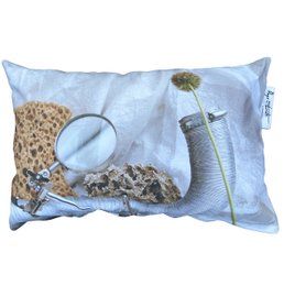 Silver outdoor pillow with floral and nature-inspired design, filled for comfort.