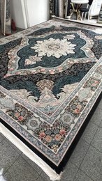 Large dark blue area rug with intricate floral and geometric patterns, suitable for living rooms or bedrooms.